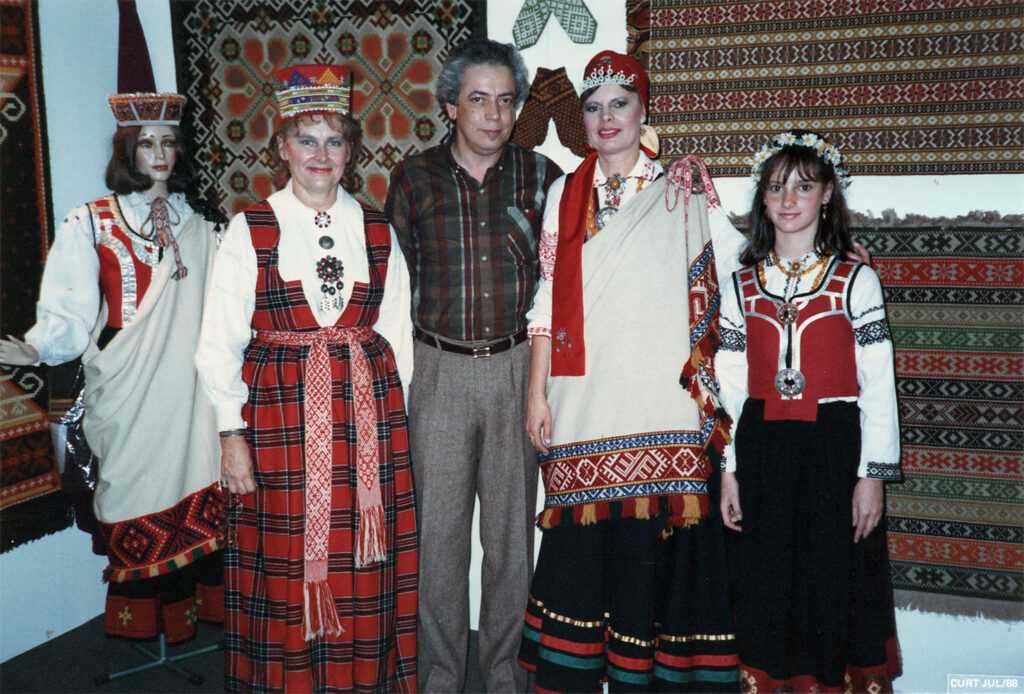 Latviešu stends imigrantu izstādē 1988. gadā Ibirapuerā, Sanpaulu, Brazīlijā. No kreisās: Ilona Gulbis Lielvārdes tautastērpā, Vicente Bicudo, Melita Bārtuls, Grace Kapins. Ilonas Gulbis dāvinājums. Foto no muzeja “Latvieši pasaulē” krājuma.